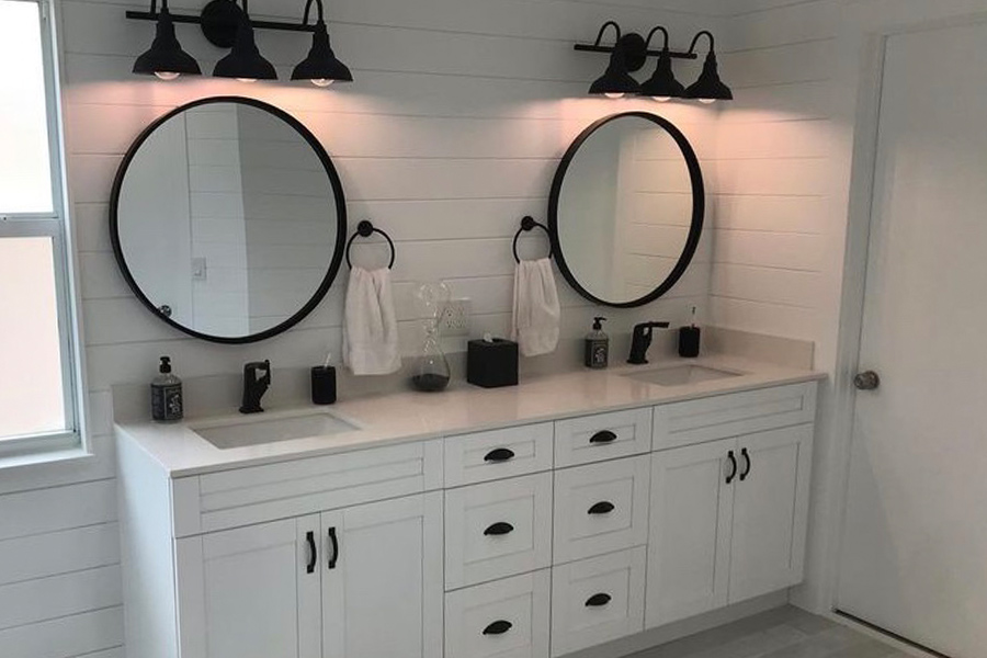 bathroom with new lighting fixtures installed and new white cabinets palm beach fl