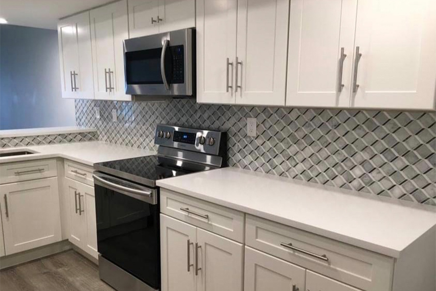 kitchen interiors remodeled with new white cabinets and backsplash installed palm beach fl